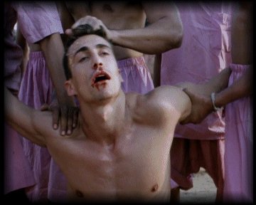 Alex is beaten by the local inmates