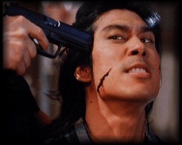 A Yakuza henchman is detained by the police